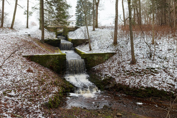 Estonian winter countryside. Cascase in the park of Palmse.