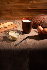 Assorted dairy products milk, cheese, eggs. rustic still life on table
