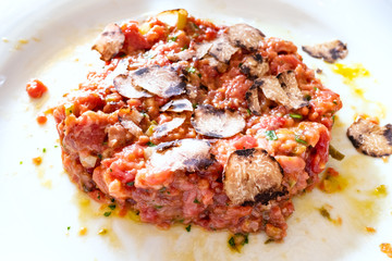 beef steak tartare with sliced truffle close up