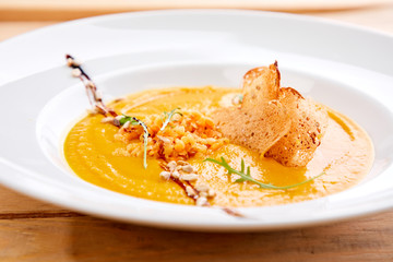 pumpkin cream soup with croutons and rice
