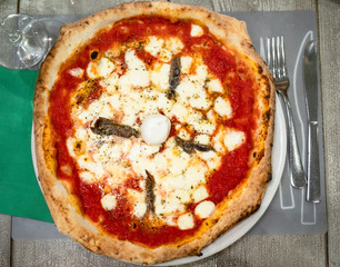 top view of italian pizza Napoli with anchovies