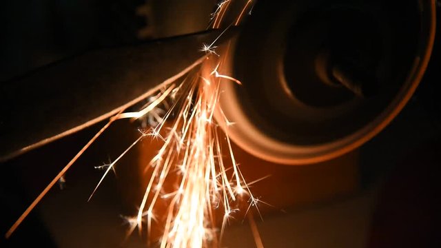Turning a knife on the machine.  Sparks from metal