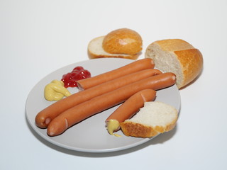 sausages with mustard, ketchup and rolls isolated on white background