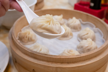 Xiao long bao soup dumpling buns with chopsticks in restaurant (Traditional Chinese food) in Taipei Taiwan