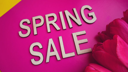 Spring sale banner with pink tulips on colorful background