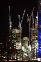 Illuminated Construction site with several cranes near Waterloo Station at night, London, England,...
