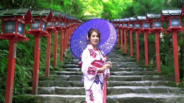 Asian women in traditional japanese kimono at  Kifune Shrine in Kyoto, Japan. Smiling woman.