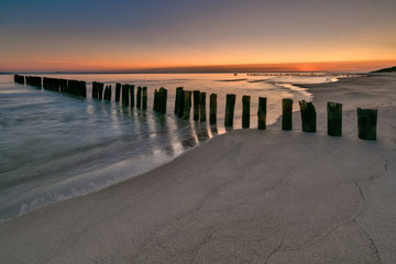 Beautiful sandy beach with a wooden breakwater, Baltic Sea, Poland