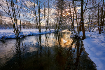 small river in a winter rural landscape, poland