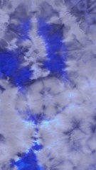 Abstract hand painted clouds  blue fabriс background with irregular colorful spots