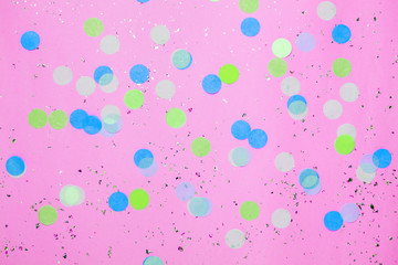 Pink confetti background. Top view, flat lay. Vibrant and festive