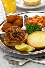 North Carolina barbecue plate ; pulled pork, hush puppies, baked beans and coleslaw