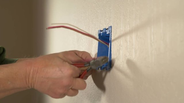 An electrician working with wires on a home remodel