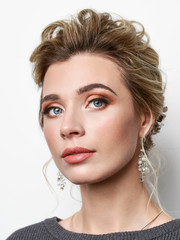 Portrait of beautiful elegant girl with blond hair, trendy styling, beautiful makeup, glossy, smooth skin posing for makeup artist social network portfolio