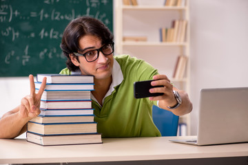Handsome student in front of chalkboard with formulas 