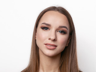 Fototapeta premium Portrait of beautiful elegant girl with blond hair, trendy styling, beautiful makeup, glossy, smooth skin posing for makeup artist social network portfolio