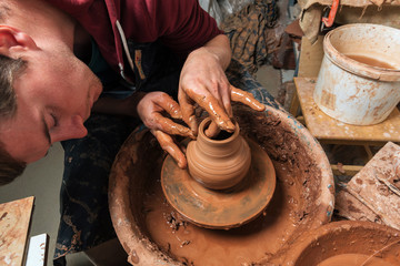 Potter at work. Workshop place.