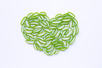 Heart shaped aloe vera slices on white