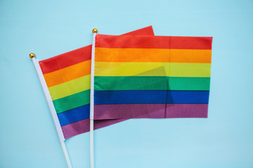 Multicolored flags of the color of the rainbow or LGBT flags on a blue background.