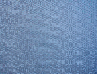 Texture of artificial radiant skin with honeycomb perforation. Abstract background, defocus.