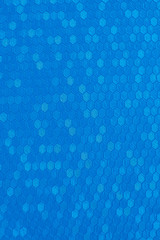 Texture of artificial radiant skin with honeycomb perforation. Abstract background, defocus.