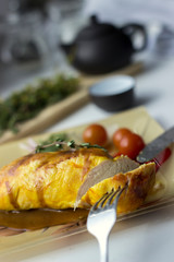 Baked chicken breast with onions and tomatoes on a white plate. Healthy food.
