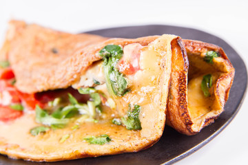 Omelette with tomatoes and fresh corn salad on a white background