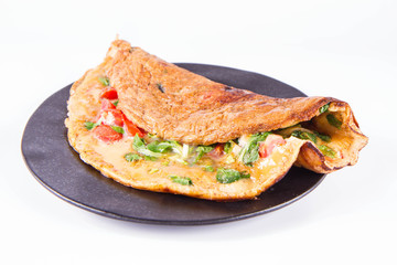 Omelette with tomatoes and fresh corn salad on a white background