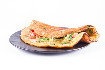 Omelette with tomatoes and fresh corn salad on a white background