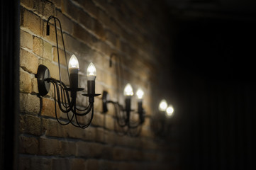 close up photo of vintage lamps on brown brick walls