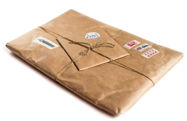 Package wrapped in craft paper on a white background.