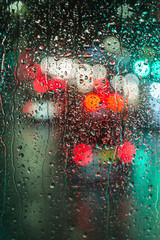 Traffic lights seen through a rainy glass pane