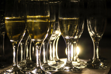 close up photo of glasses of champagne in the dark on the table