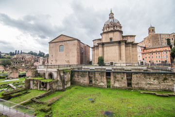 Fototapeta na wymiar Rome, Italy - November, 2018: Landscape section of the Roman Forum in Rome. View on the Church of Saint Luca e Martina, the Curia Julia or Senate House and the National Monument to Victor Emmanuel II