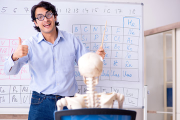 Young male chemist teacher and student skeleton 