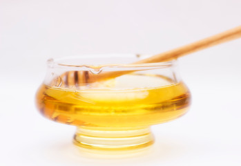 Honey pot and dipper isolated on white background, copy text