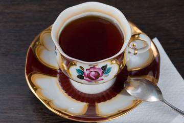 cup with a hot drink, stands on a wooden background