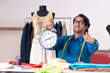 Young male tailor working at workshop 