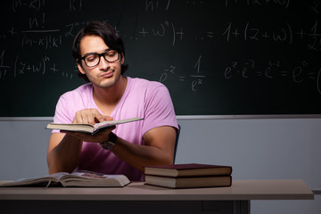 Young male student sitting in classroom