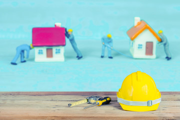 yellow construction safety helmet on wood