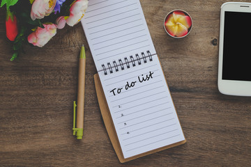 To Do List text on book note with cup of coffee, pen and smartphone.