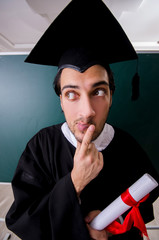 Graduate student in front of green board 