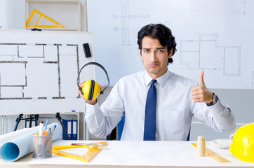 Young handsome architect working on the project 