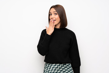 Young woman over white wall with shocked facial expression