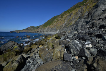 image of black sand with stones