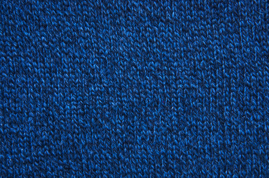The texture of a knitted woolen fabric blue.