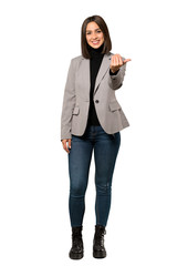 A full-length shot of a Young business woman inviting to come with hand. Happy that you came over...