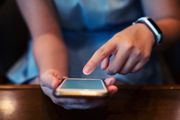 Closeup of hands using internet on mobile. Wireless network connection technology concept.