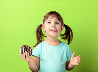 Four-year-old girl eat donut.