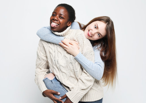 Multiethnic friendship concept. Cheerful European and African women.